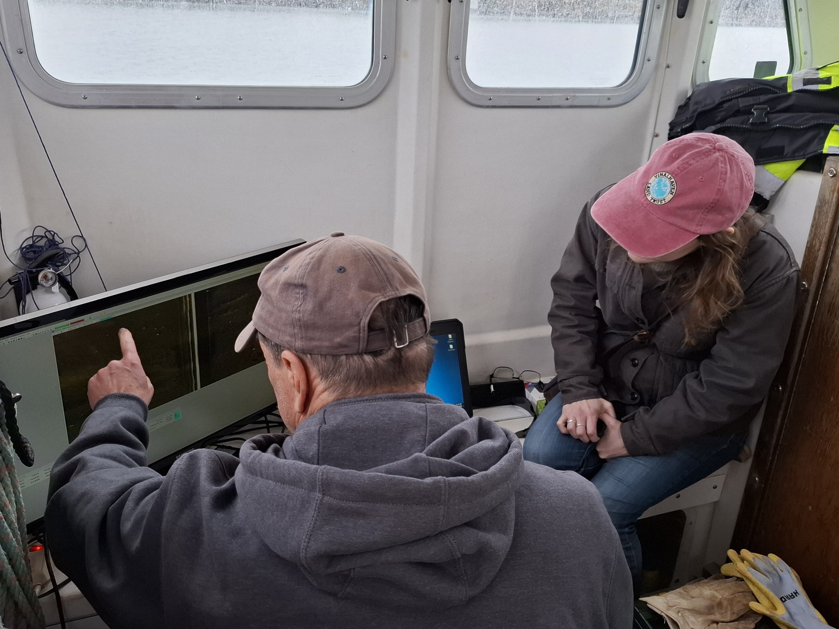 Vince Capone points out features on the side-scan display on the boat