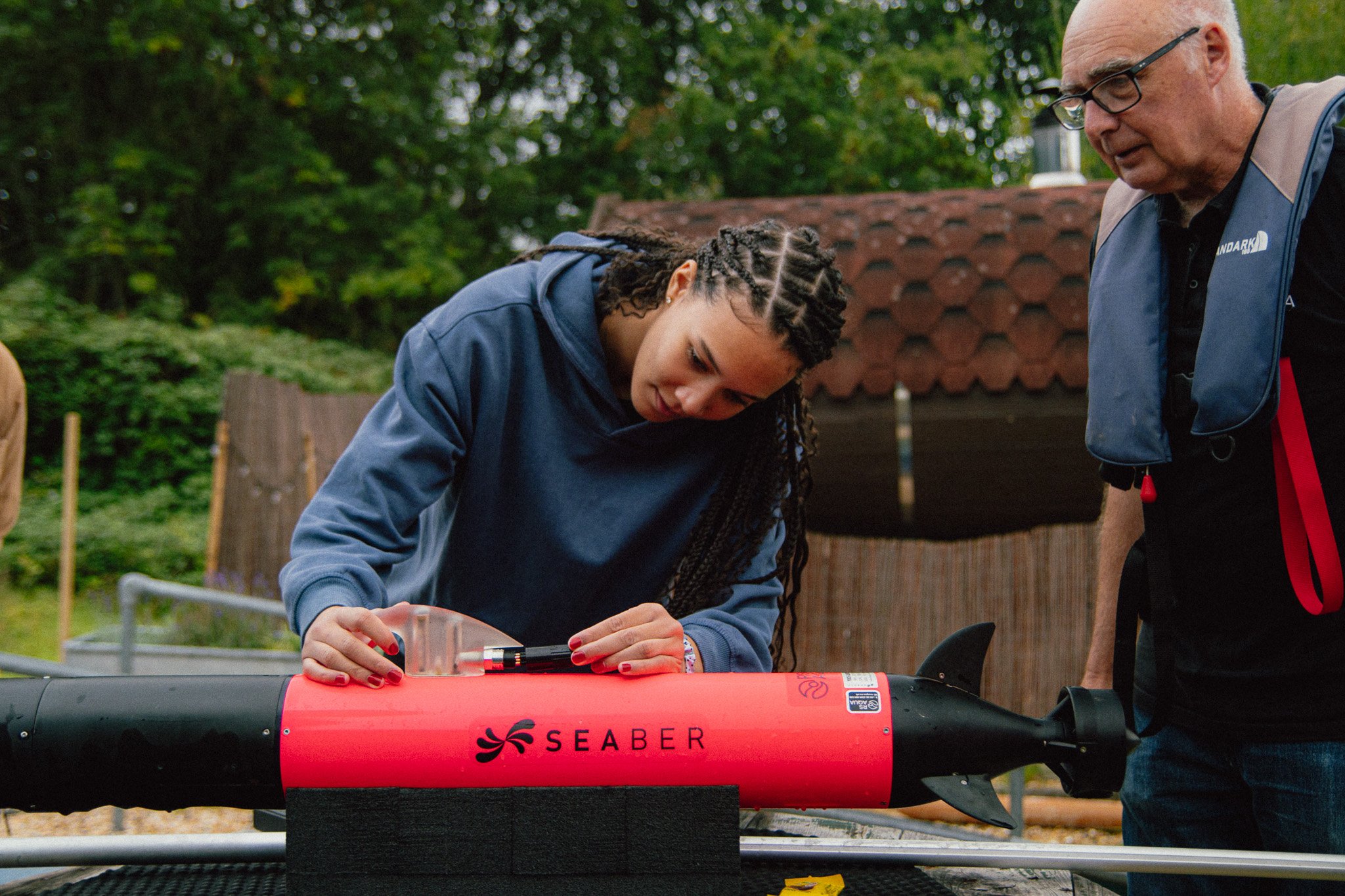 A student handles an AUV on shore